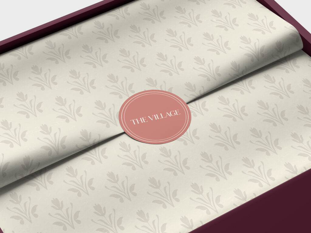 The Village branded paper in a box, representing community and membership in San Antonio.