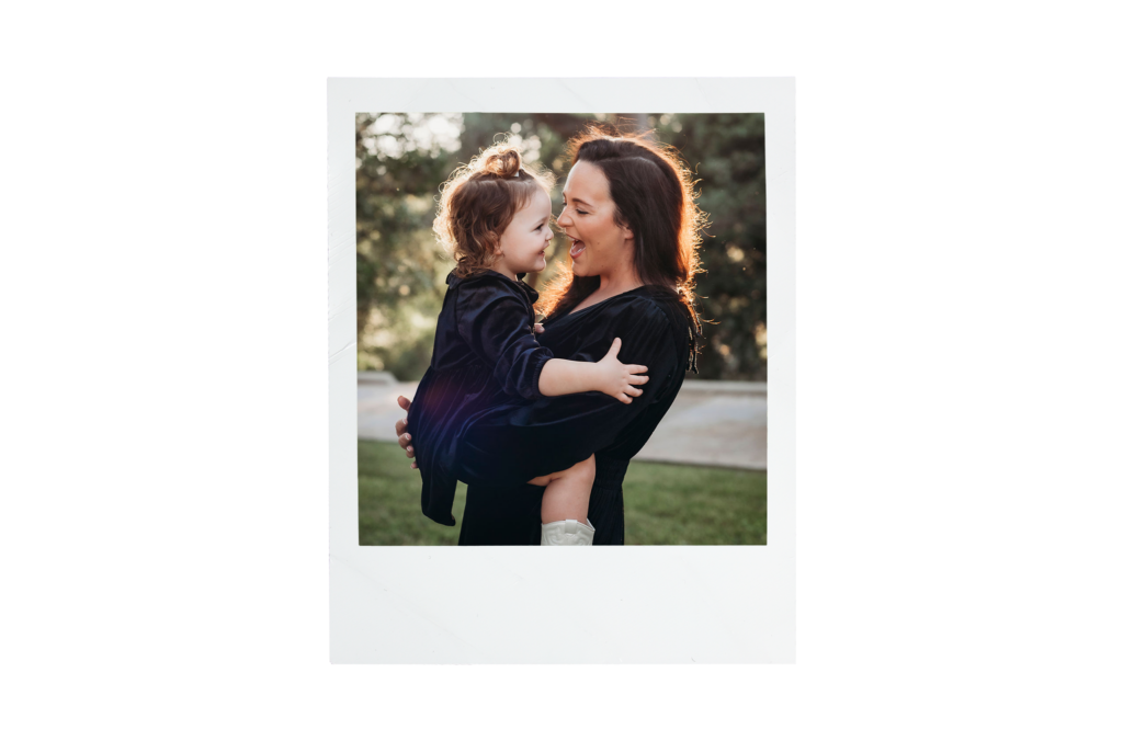 A woman and young girl from The Village social club sharing a joyful moment outdoors in San Antonio.