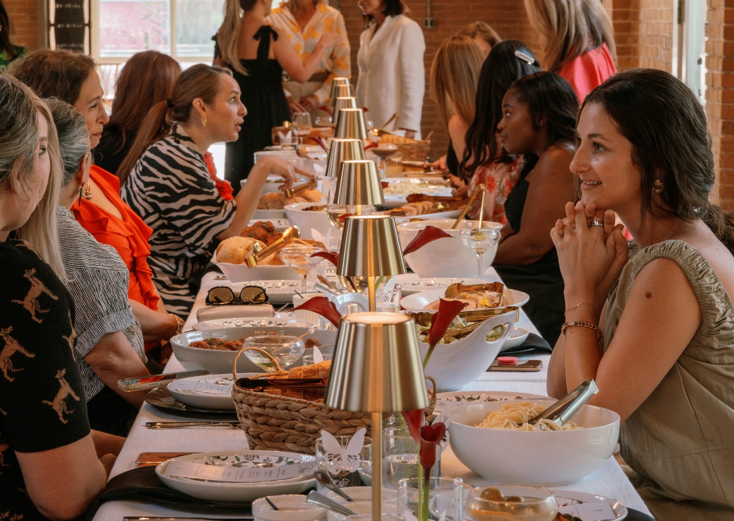 Membership event at The Village Women around celebratory table